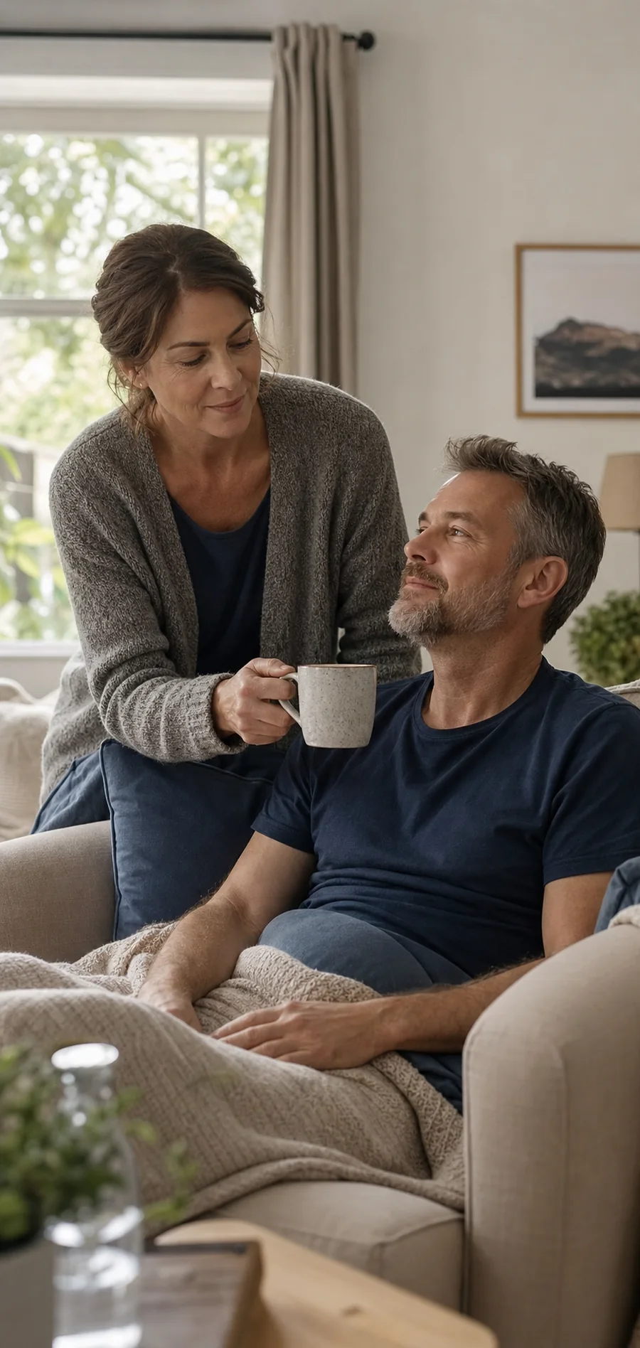 A man recovering at home while his wife brings him tea